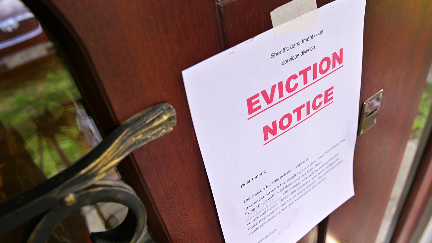Eviction notice hanging on brownstone door